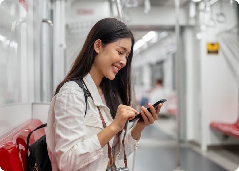 A person on their phone on the train