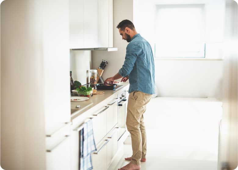 A man preparing a meal in his kitchen