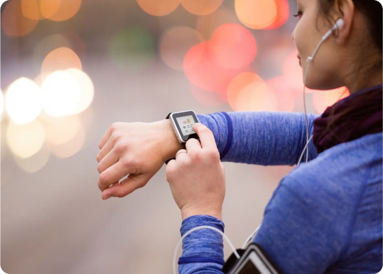 A woman using her smart watch while exercising