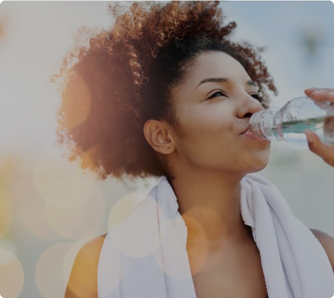 Person drinking water after exercise