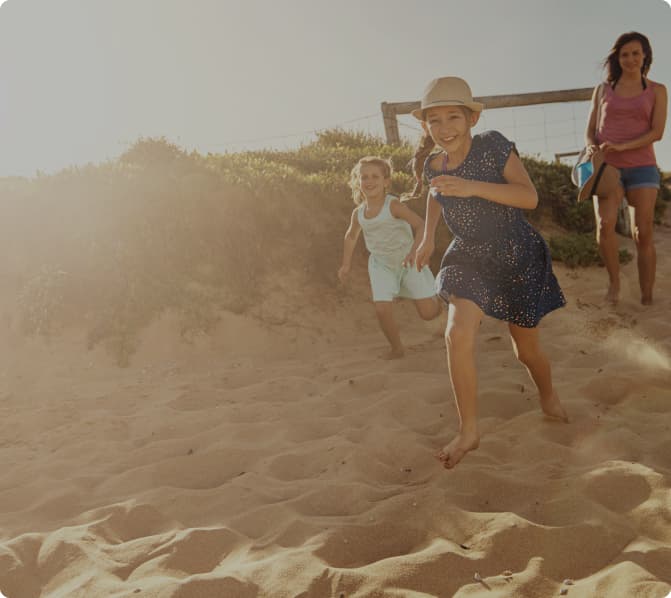 Two girls running on the beach