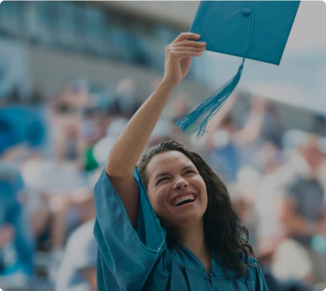 A woman throwing her cap on graduation day