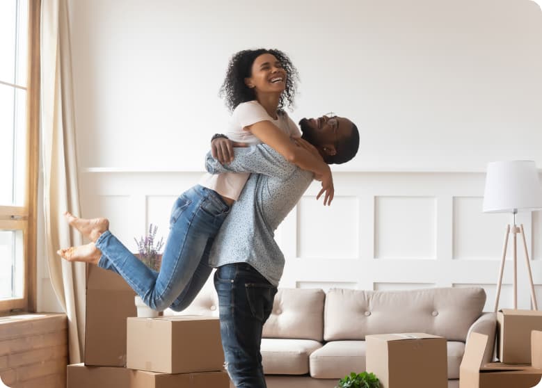 A couple moving into their new home and smiling