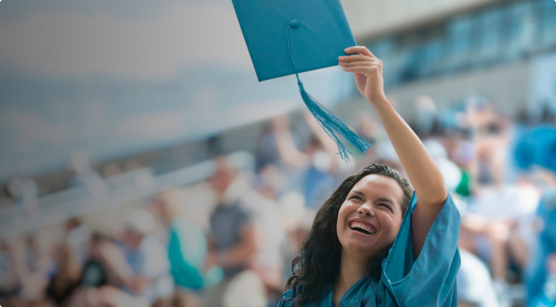 A woman throwing her cap on graduation day