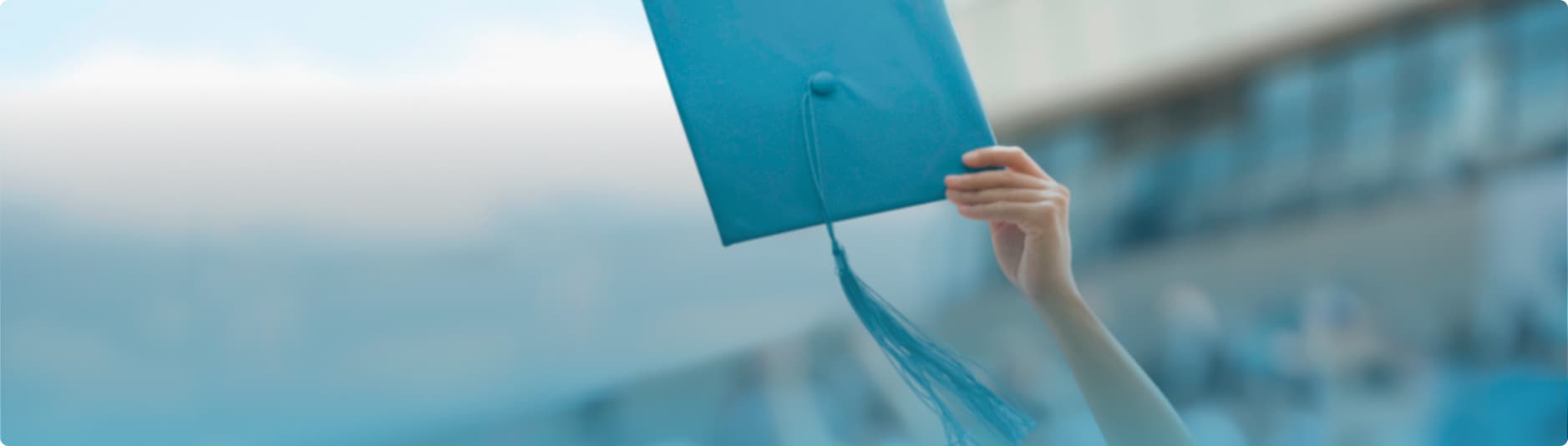 A woman throwing her cap on graduation day