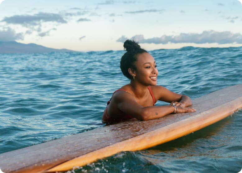 A surfer taking a break in the ocean