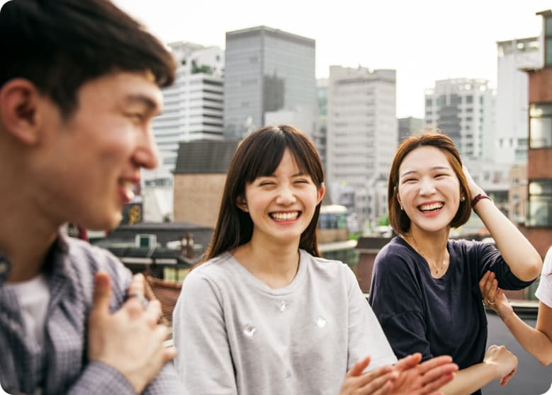 A group of friends laughing on a rooftop